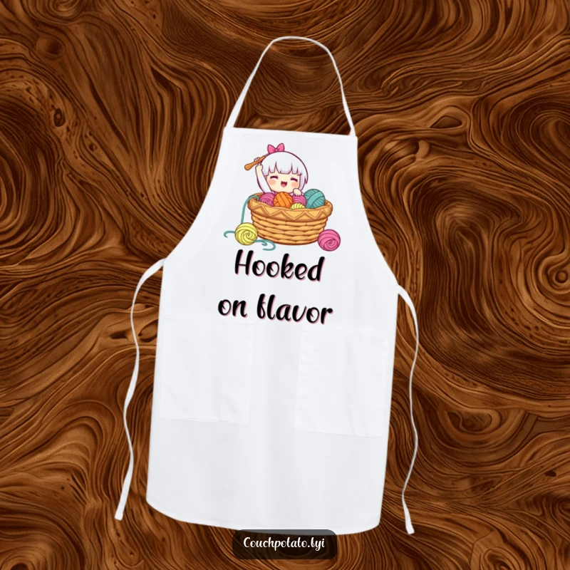 Funny apron showing a character gleefully dropping a crochet hook into a basket of yarn, designed for protection and cheer.