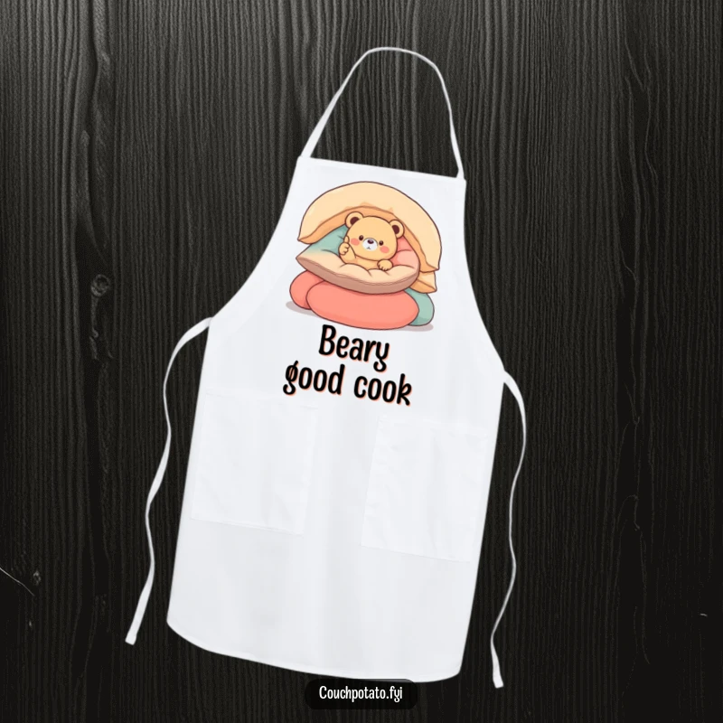 Funny round bear apron with a small, round bear nestled in cushions, giving a thumbs up, perfect for cheerful cooking.