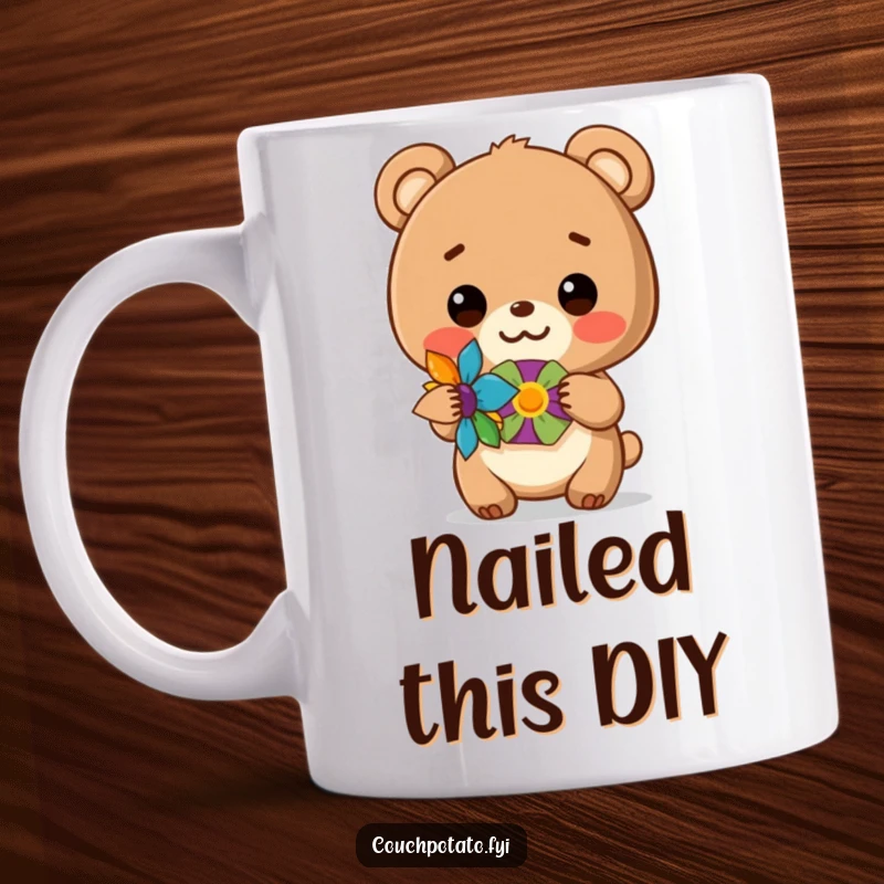 Funny mug featuring a smiling bear cub triumphantly holding a colorful, finished craft project, celebrating creative accomplishment.