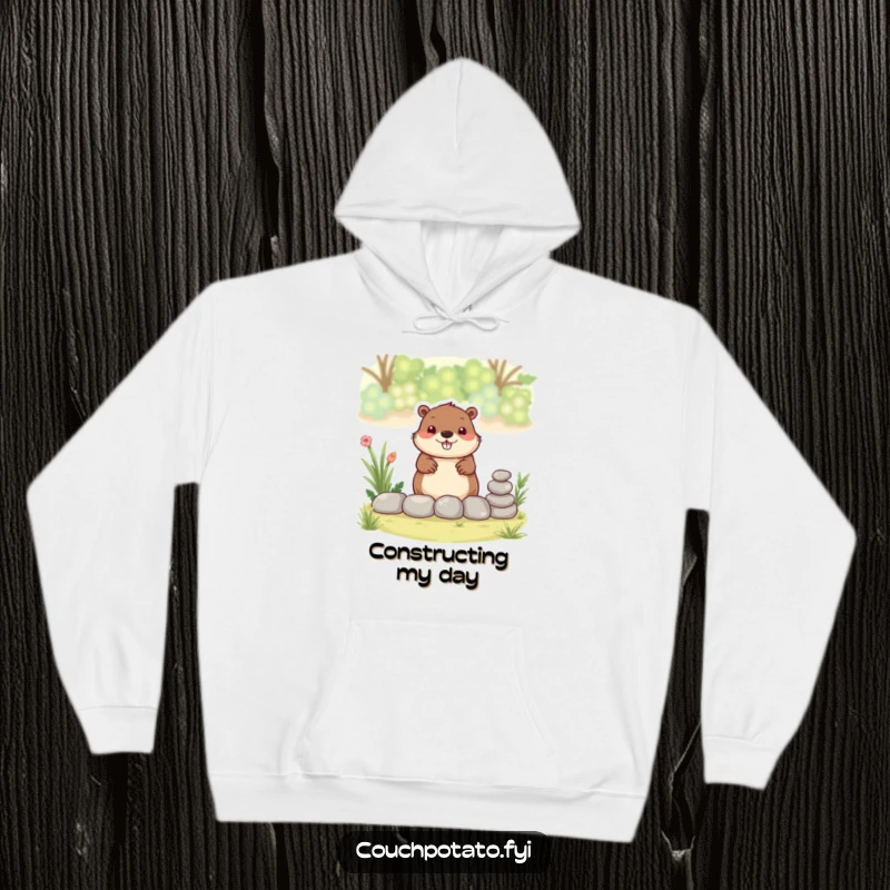 Funny beaver hoodie, a smiling beaver carefully stacks small stones to form a charming garden border.