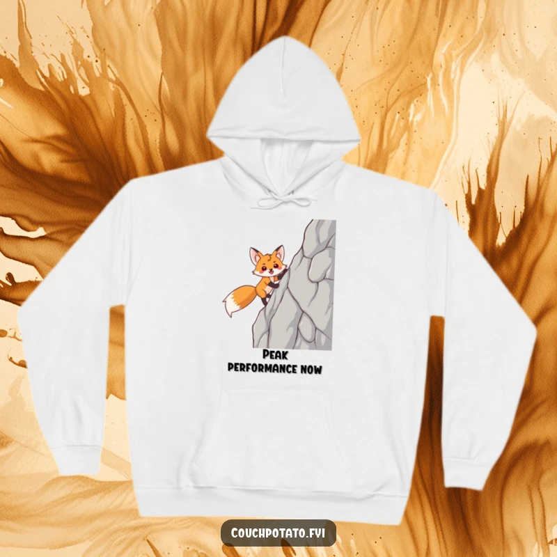 Funny fox hoodie with a smiling, triumphant fox character scaling a steep rock face, offering warmth and inspiration.