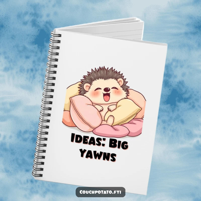 Funny hedgehog snuggled amongst soft cushions yawning widely, designed on the cover of a notebook.