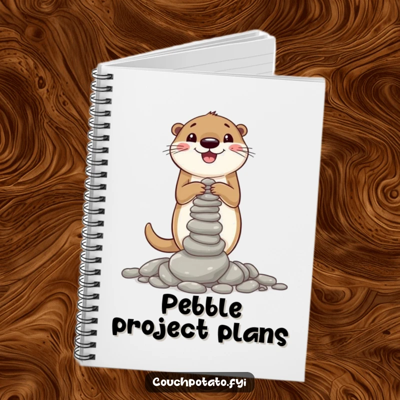 Funny notebook cover illustrated with a cheerful otter focused on building a wobbly tower of pebbles, inspiring creative endeavors.