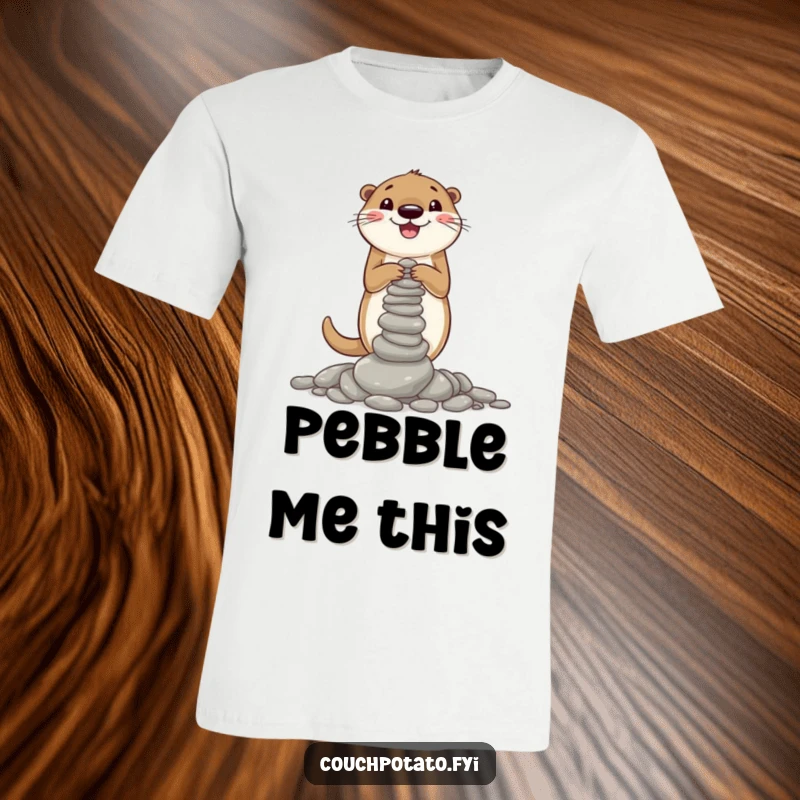 Funny T-shirt featuring a joyful otter meticulously stacking a precarious tower of pebbles, capturing its delightful construction efforts.