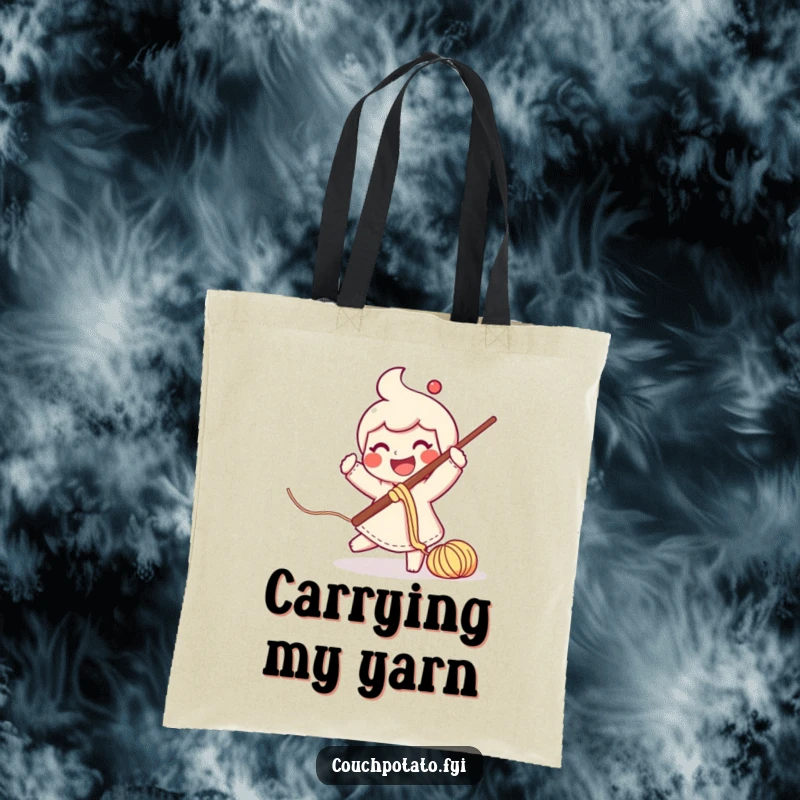 Funny smiling character swinging a crochet hook with yarn trailing, on a reusable tote bag.