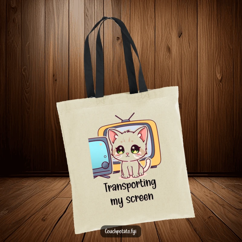 Funny wide-eyed kitten intensely watching a television, on a tote bag, illustrating a humorous concentration on screen content.